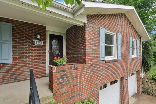 1154 Bucknell, Monroeville, PA 15146 - doorway to property with a garage, concrete driveway, and brick siding
