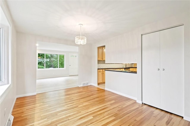 1154 Bucknell, Monroeville, PA 15146 - unfurnished living room with a chandelier and light wood-style floors
