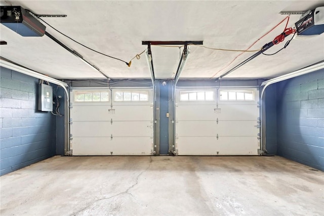 1154 Bucknell, Monroeville, PA 15146 - garage with electric panel, a garage door opener, and concrete block wall