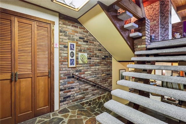 890 Pearce Mill Rd, Pine Twp Nal, PA 15090 - stairs with stone floors, brick wall, and vaulted ceiling