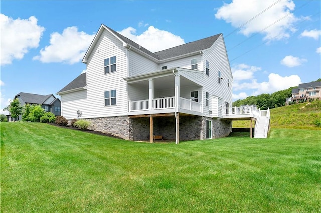 107 Abigail Dr, Adams Twp, PA 16046 - rear view of property featuring a lawn, a deck, and stone siding
