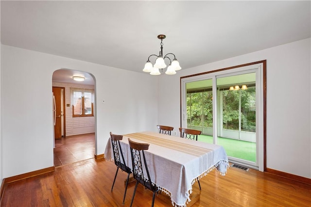 138 Link Ave, Ross Twp, PA 15237 - dining area featuring arched walkways, wood finished floors, and a chandelier