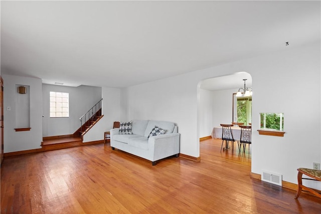 138 Link Ave, Ross Twp, PA 15237 - living area with arched walkways, plenty of natural light, light wood-style flooring, and stairs