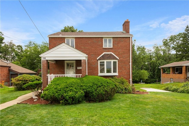 138 Link Ave, Ross Twp, PA 15237 - view of front of house featuring a chimney, a front lawn, brick siding, and covered porch