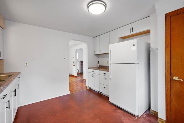 138 Link Ave, Ross Twp, PA 15237 - kitchen featuring freestanding refrigerator, arched walkways, and white cabinetry