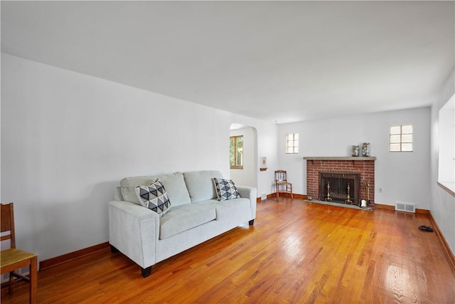 138 Link Ave, Ross Twp, PA 15237 - living room featuring light wood-style flooring, a fireplace, and arched walkways