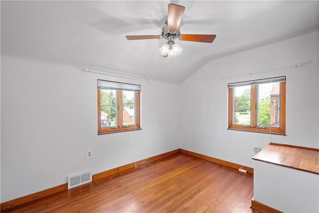 138 Link Ave, Ross Twp, PA 15237 - empty room featuring vaulted ceiling, healthy amount of natural light, wood finished floors, and a ceiling fan