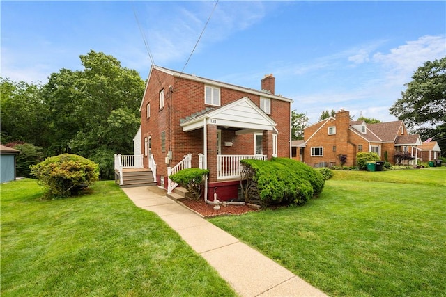 138 Link Ave, Ross Twp, PA 15237 - view of front of home featuring brick siding, a chimney, a front yard, and covered porch