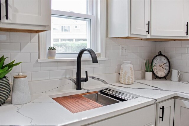 746 Agnew Rd, Baldwin Boro, PA 15227 - kitchen view of white cabinets, tasteful backsplash, and light stone countertops