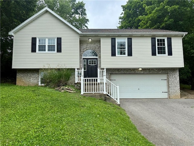 109 Remil Dr, Twp Of But Se, PA 16001 - bi-level home featuring asphalt driveway, an attached garage, a front yard, and brick siding