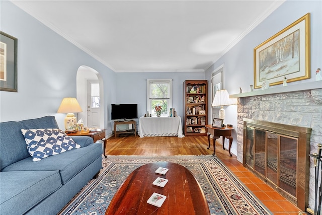 221 Springer, Moon/Crescent Twp, PA 15108 - living area featuring arched walkways, crown molding, a stone fireplace, and wood finished floors
