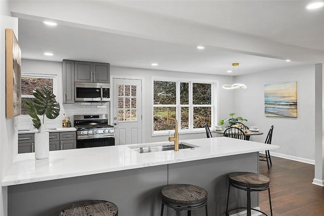 1171 Arrowood Dr, Mt Lebanon, PA 15243 - kitchen featuring stainless steel appliances, gray cabinetry, dark wood-style flooring, a breakfast bar, and recessed lighting
