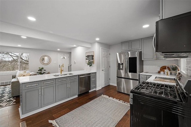1171 Arrowood Dr, Mt Lebanon, PA 15243 - kitchen with black appliances, a peninsula, gray cabinets, light countertops, and backsplash