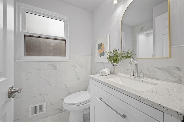 1171 Arrowood Dr, Mt Lebanon, PA 15243 - bathroom with vanity, marble finish flooring, tile walls, and a wainscoted wall