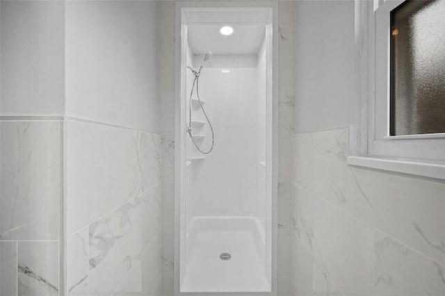 1171 Arrowood Dr, Mt Lebanon, PA 15243 - bathroom featuring a shower, tile walls, and wainscoting