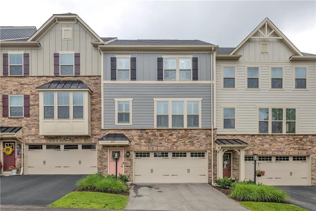 2005 Lampl Ln, Penn Twp Wml, PA 15644 - view of property with board and batten siding, stone siding, and a garage
