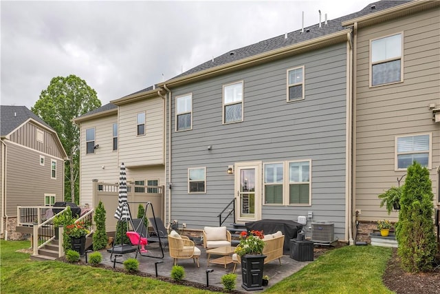 2005 Lampl Ln, Penn Twp Wml, PA 15644 - rear view of house with an outdoor hangout area, a garage, a patio area, and a yard