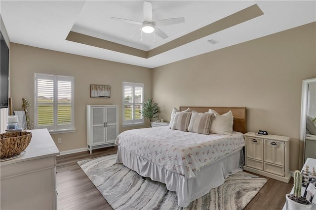 2005 Lampl Ln, Penn Twp Wml, PA 15644 - bedroom featuring a tray ceiling, dark wood-style flooring, and a ceiling fan