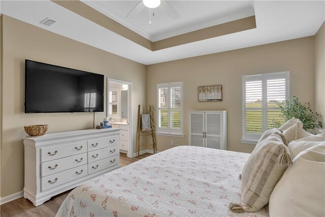 2005 Lampl Ln, Penn Twp Wml, PA 15644 - bedroom featuring wood finished floors, multiple windows, ornamental molding, a raised ceiling, and connected bathroom