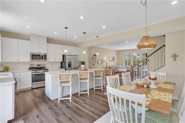 2005 Lampl Ln, Penn Twp Wml, PA 15644 - kitchen with stainless steel appliances, a center island, wood finished floors, light countertops, and recessed lighting