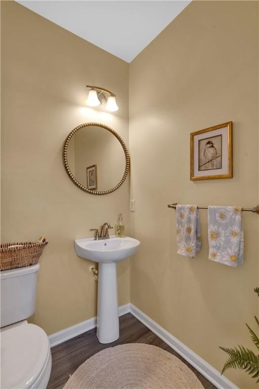 2005 Lampl Ln, Penn Twp Wml, PA 15644 - half bath featuring wood finished floors and toilet