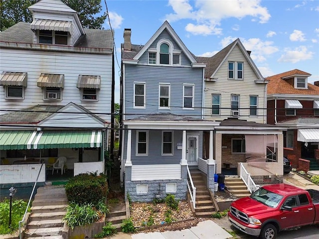 3103 Shadeland Ave, Brighton Heights, PA 15212 - townhome / multi-family property with stairway, a porch, and a chimney
