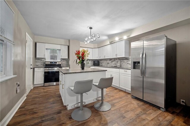 3103 Shadeland Ave, Brighton Heights, PA 15212 - kitchen featuring appliances with stainless steel finishes, backsplash, a center island, and a chandelier
