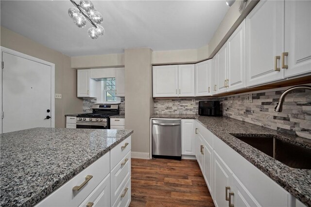 3103 Shadeland Ave, Brighton Heights, PA 15212 - kitchen featuring appliances with stainless steel finishes, light stone counters, dark wood-type flooring, and white cabinets