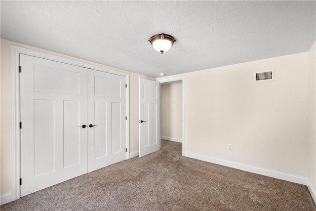 445/447 Georgetown Rd, Cecil, PA 15055 - unfurnished bedroom featuring carpet floors, a textured ceiling, and a closet