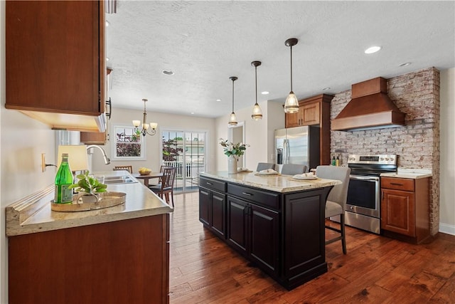 445/447 Georgetown Rd, Cecil, PA 15055 - kitchen with custom range hood, appliances with stainless steel finishes, a breakfast bar, a textured ceiling, and dark wood finished floors