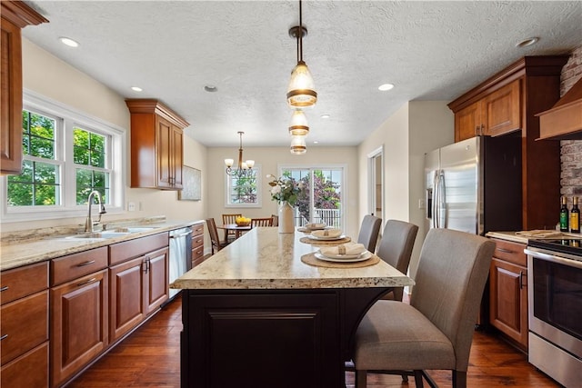 445/447 Georgetown Rd, Cecil, PA 15055 - kitchen featuring appliances with stainless steel finishes, dark wood finished floors, a breakfast bar area, a center island, and light stone counters