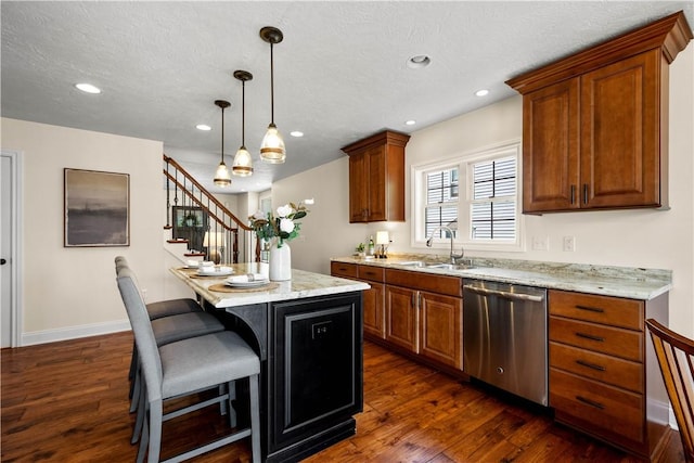 445/447 Georgetown Rd, Cecil, PA 15055 - kitchen with stainless steel dishwasher, dark wood finished floors, a center island, brown cabinets, and a breakfast bar