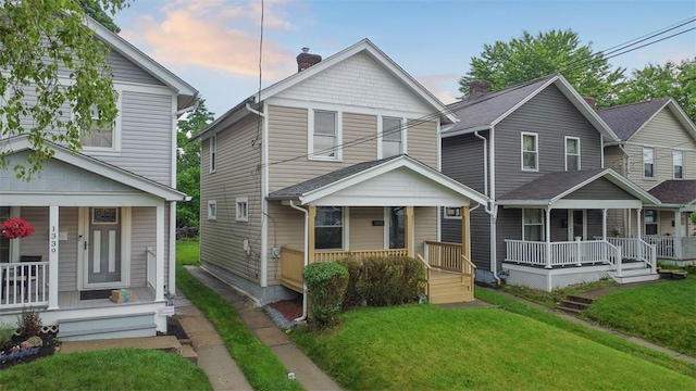 1341 4th Ave, Coraopolis, PA 15108 - view of front of house featuring a porch, a chimney, and a front yard