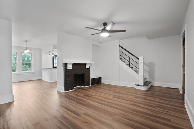 1341 4th Ave, Coraopolis, PA 15108 - unfurnished living room featuring stairway, ceiling fan, wood finished floors, and a fireplace