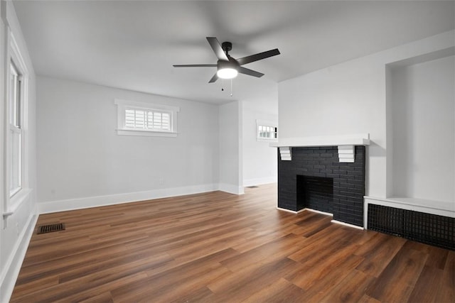 1341 4th Ave, Coraopolis, PA 15108 - unfurnished living room featuring a brick fireplace, ceiling fan, and wood finished floors