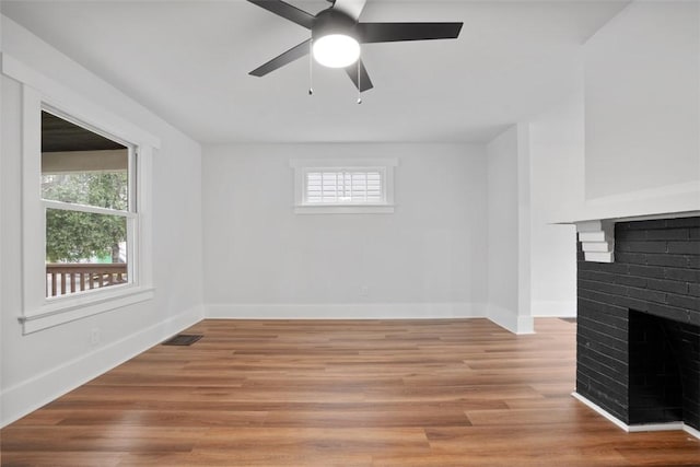 1341 4th Ave, Coraopolis, PA 15108 - unfurnished living room with a fireplace, ceiling fan, and light wood-style floors