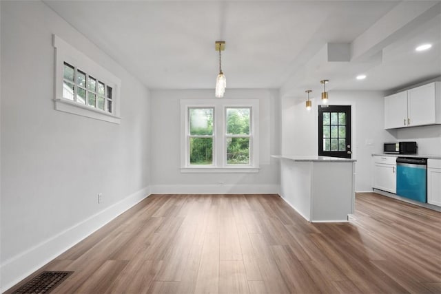 1341 4th Ave, Coraopolis, PA 15108 - kitchen featuring dishwasher, white cabinets, wood finished floors, pendant lighting, and a peninsula