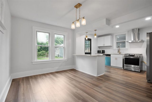1341 4th Ave, Coraopolis, PA 15108 - kitchen featuring appliances with stainless steel finishes, wall chimney exhaust hood, white cabinetry, dark wood-style flooring, and light countertops