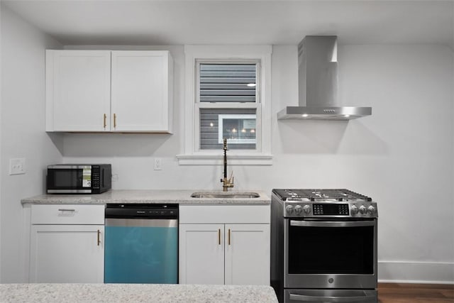 1341 4th Ave, Coraopolis, PA 15108 - kitchen featuring wall chimney exhaust hood, appliances with stainless steel finishes, white cabinetry, wood finished floors, and light stone counters