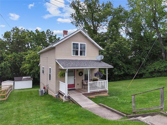 237 Prichard Ave, Centerville, PA 15358 - view of front of house featuring covered porch, a front yard, a chimney, an outbuilding, and a shingled roof