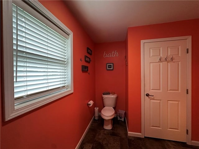 bathroom featuring baseboards and toilet