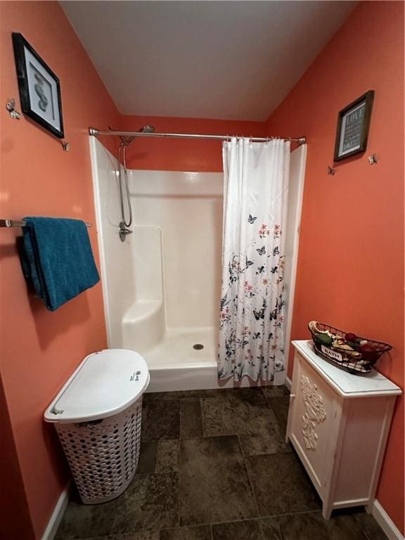 bathroom featuring a shower stall and lofted ceiling