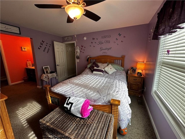 carpeted bedroom with ceiling fan and baseboards