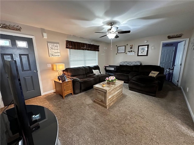 carpeted living room featuring ceiling fan and baseboards