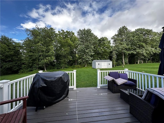 deck featuring a lawn, grilling area, a storage unit, and view of scattered trees