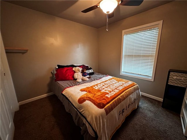 bedroom with dark colored carpet and a ceiling fan