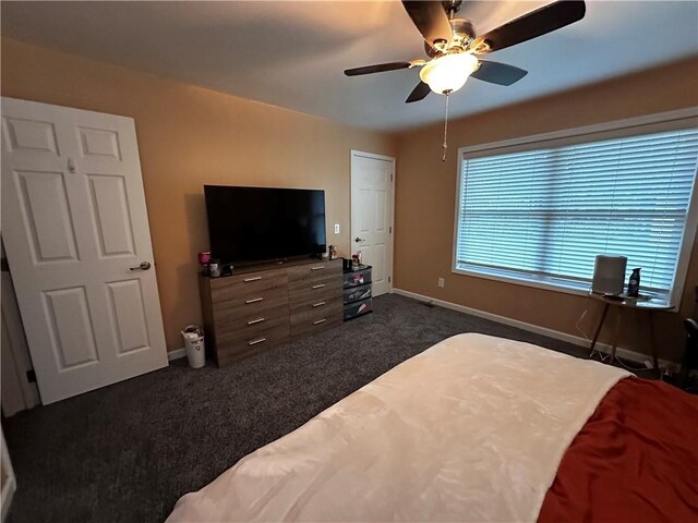 bedroom with dark colored carpet and ceiling fan