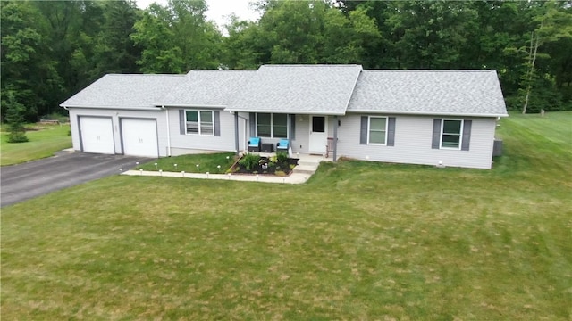 single story home with a garage, asphalt driveway, a porch, and a front yard