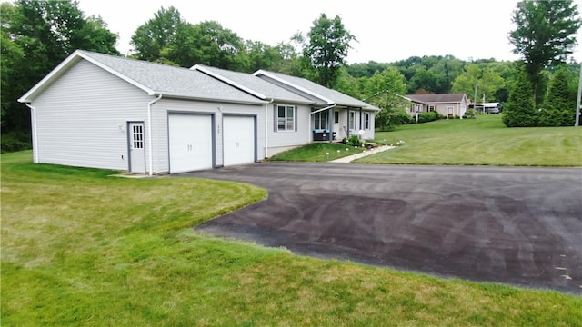 ranch-style house with a garage, asphalt driveway, and a front yard