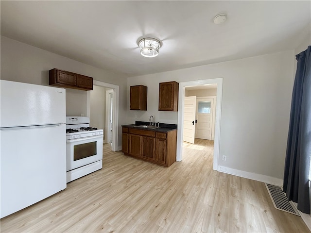 648 Jack St, City Of Greensburg, PA 15601 - kitchen featuring white appliances, light wood-style floors, and dark countertops
